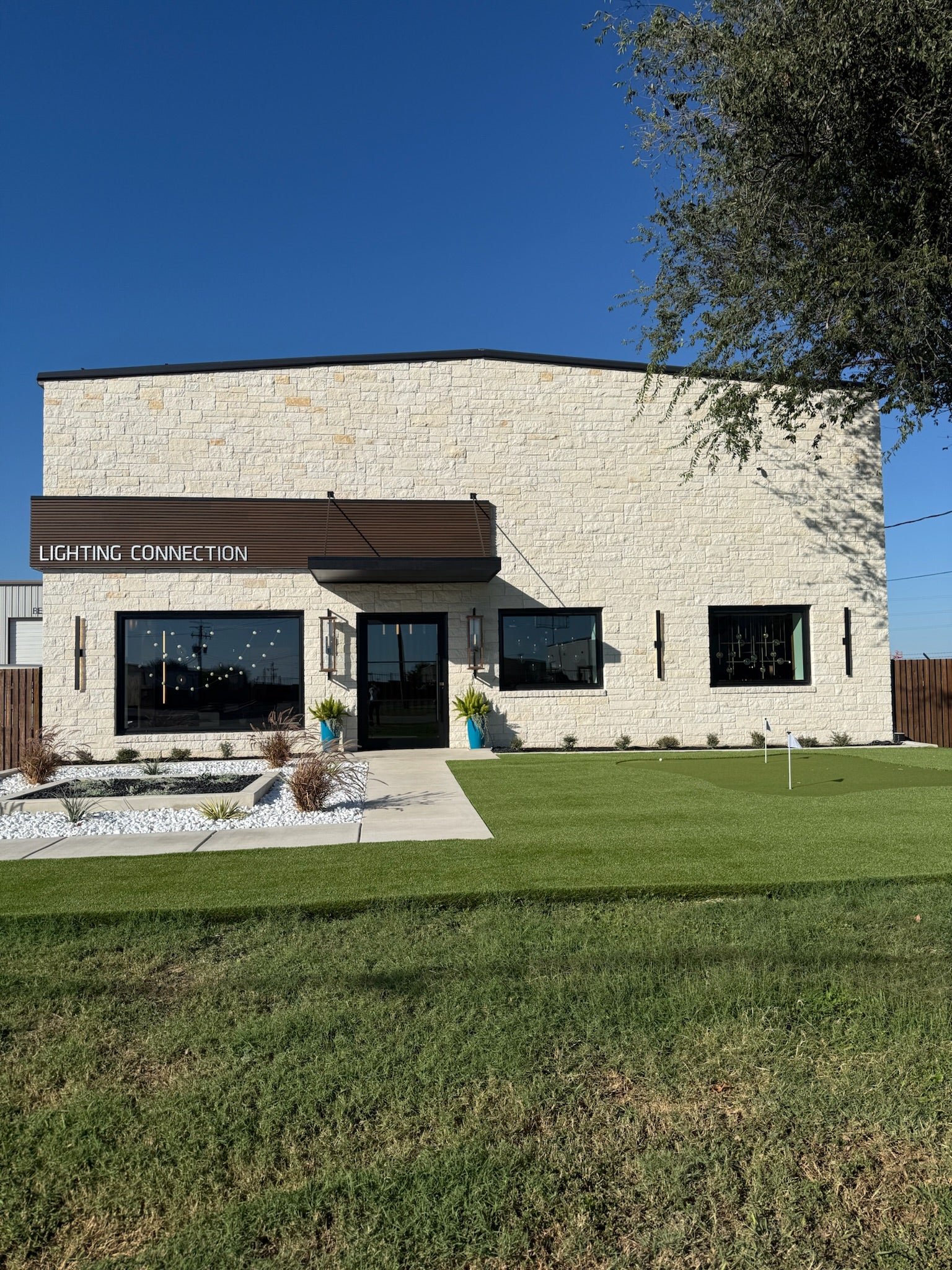 Modern building with 'Lighting Connection' sign on a clear day